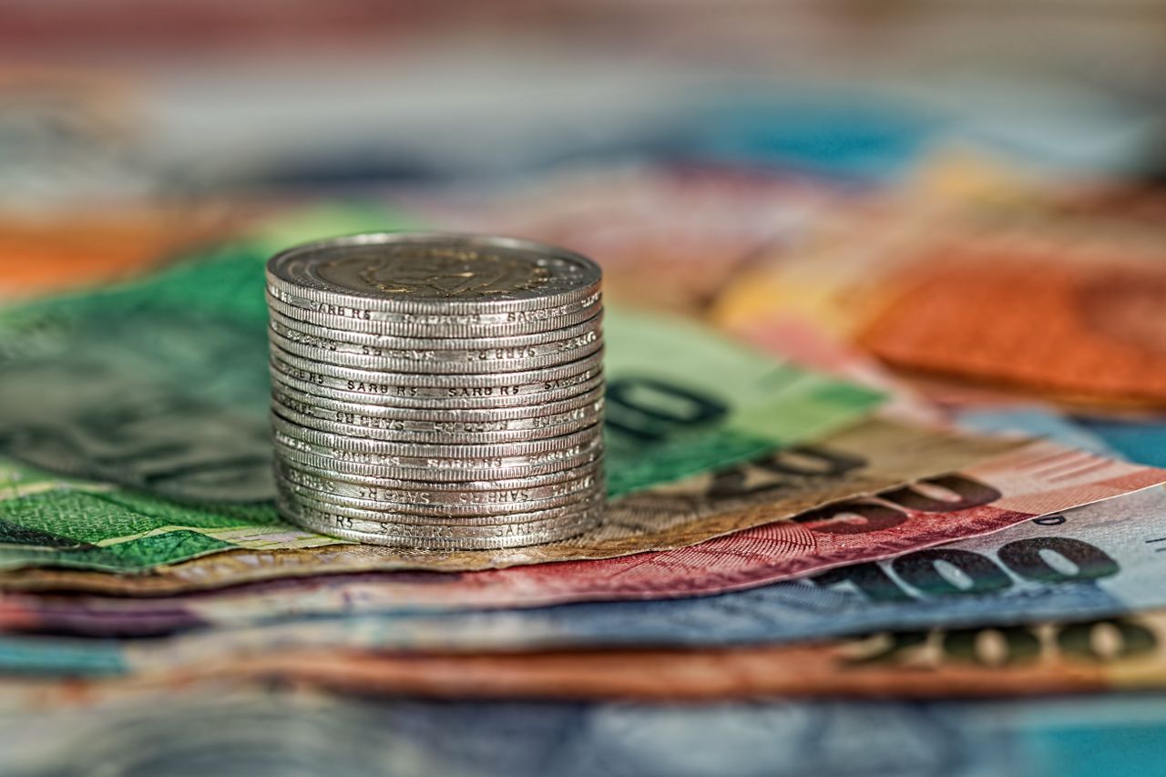 A split image of a person working and money growing on its own, representing active and passive income