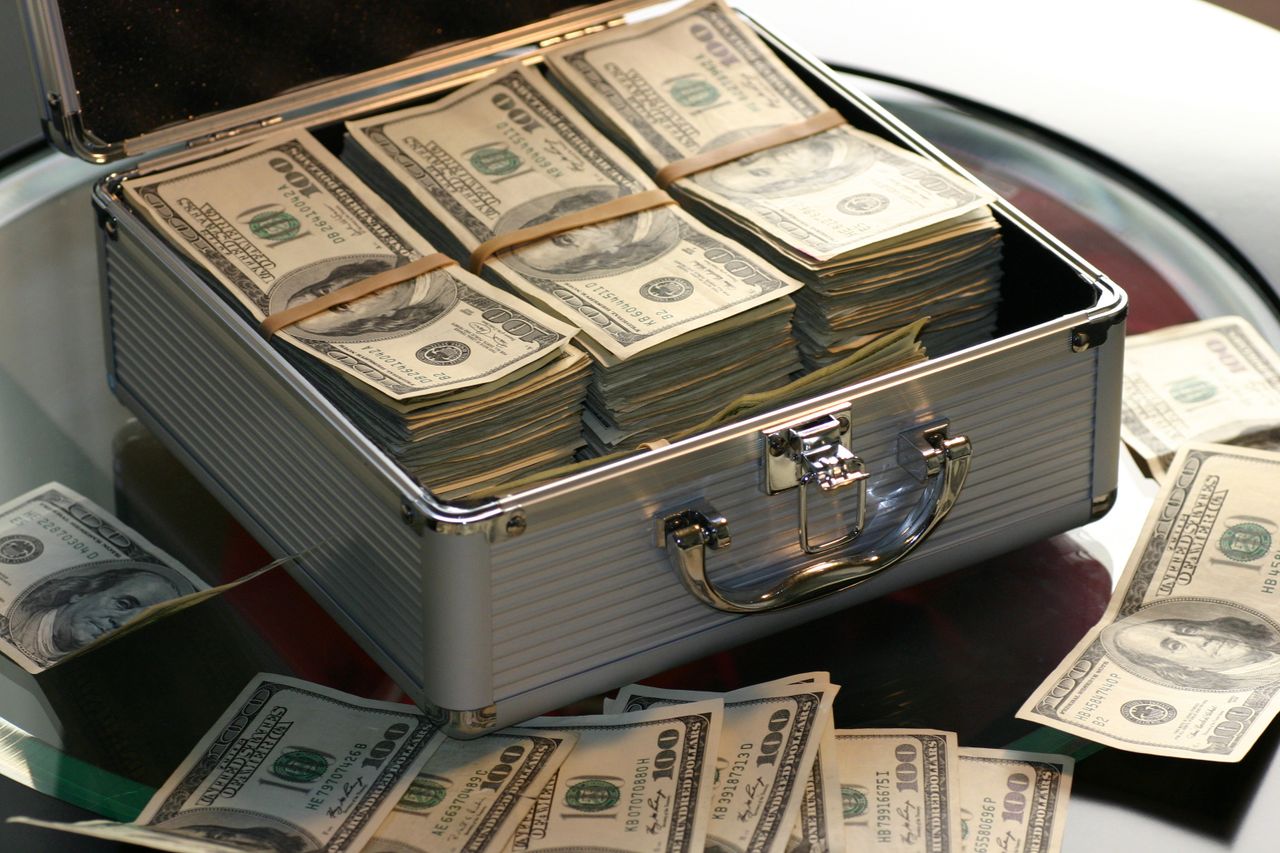 Several small streams of coins flowing into one container, representing multiple income streams