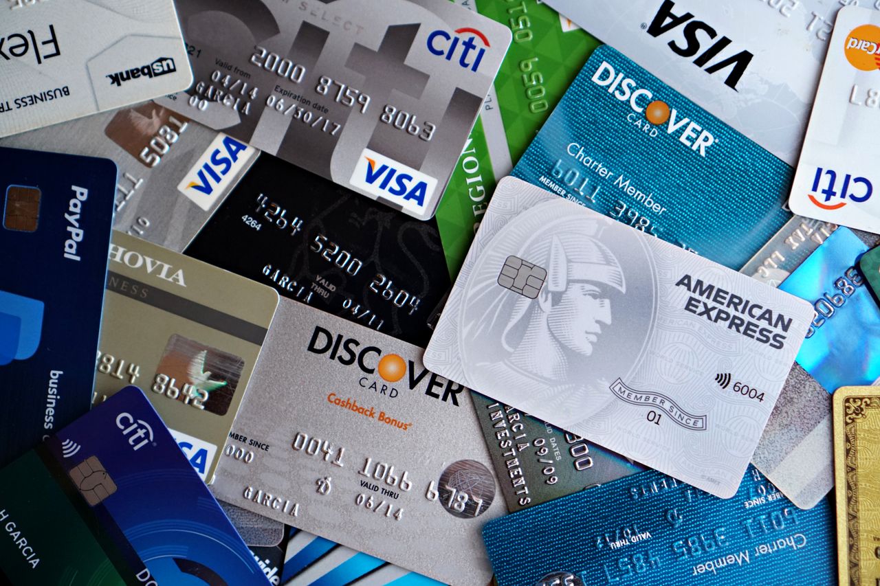 Assorted credit and debit cards laid out, weighing a balance transfer between them