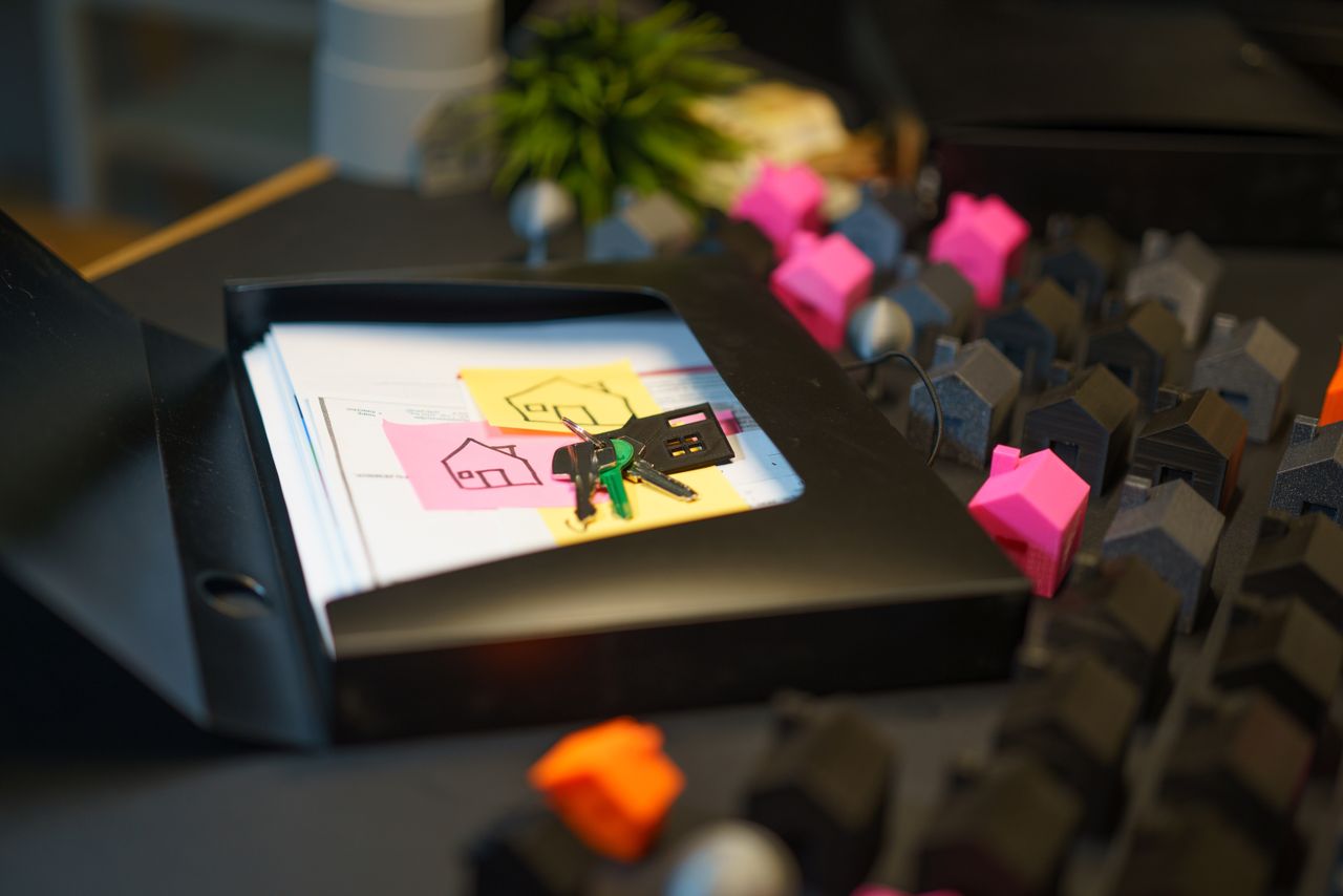 House keys and documents on a desk, weighing a decision to borrow against home equity