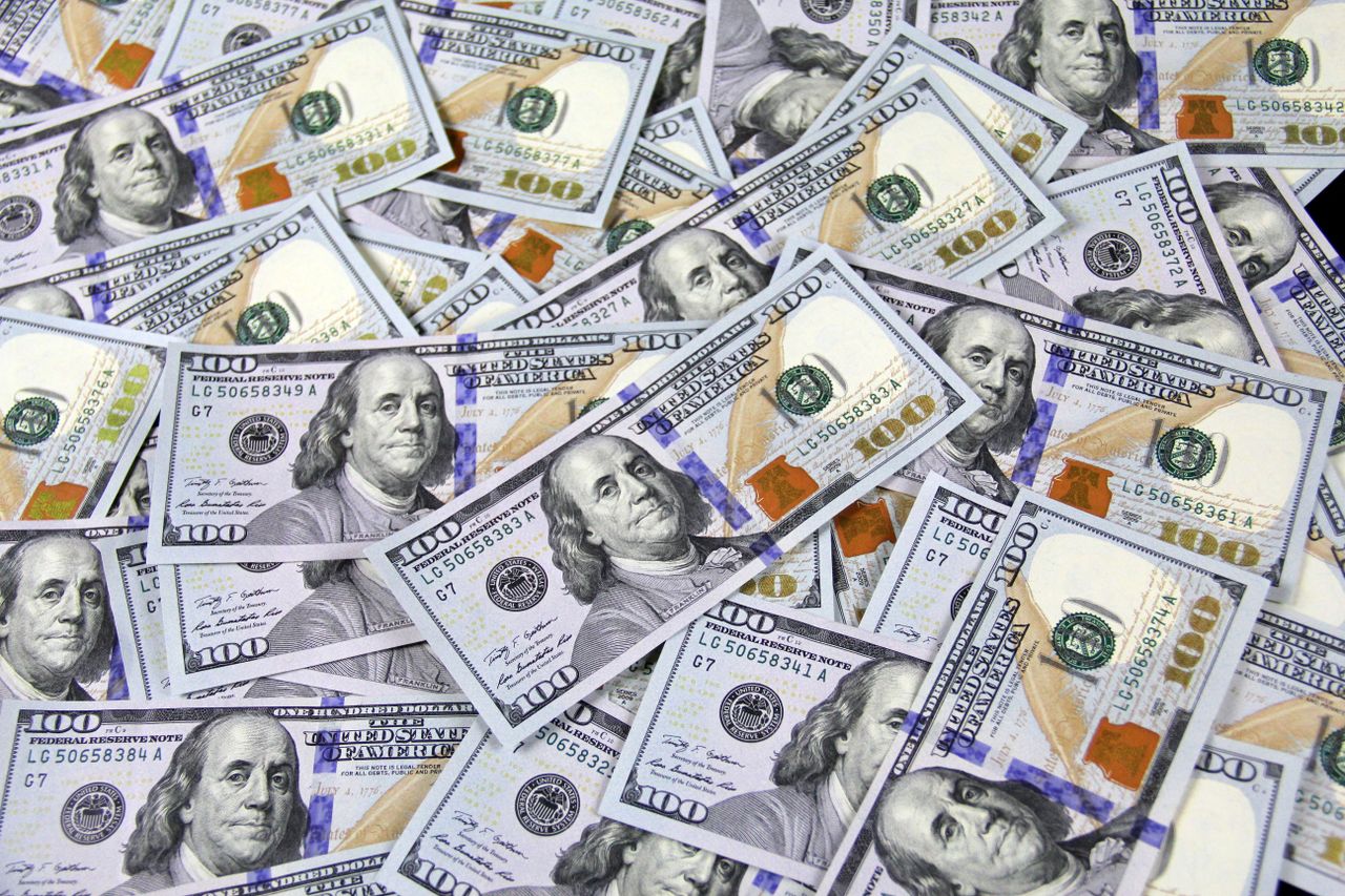 Japanese yen banknotes beside a rising US dollar exchange rate display