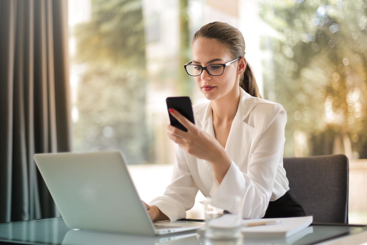 Reviewing spending on a phone late at night, catching budgeting mistakes early
