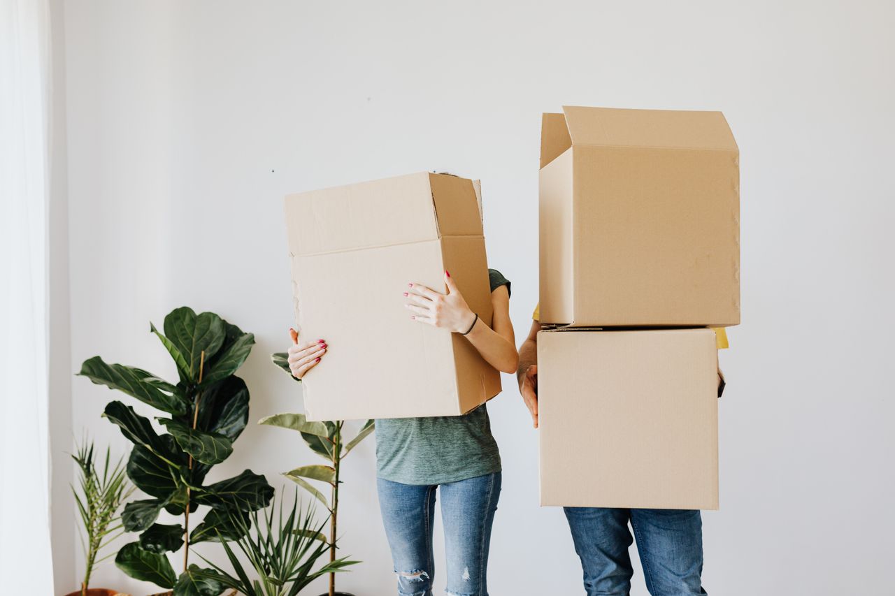 Person packing handmade goods for a side hustle order at home