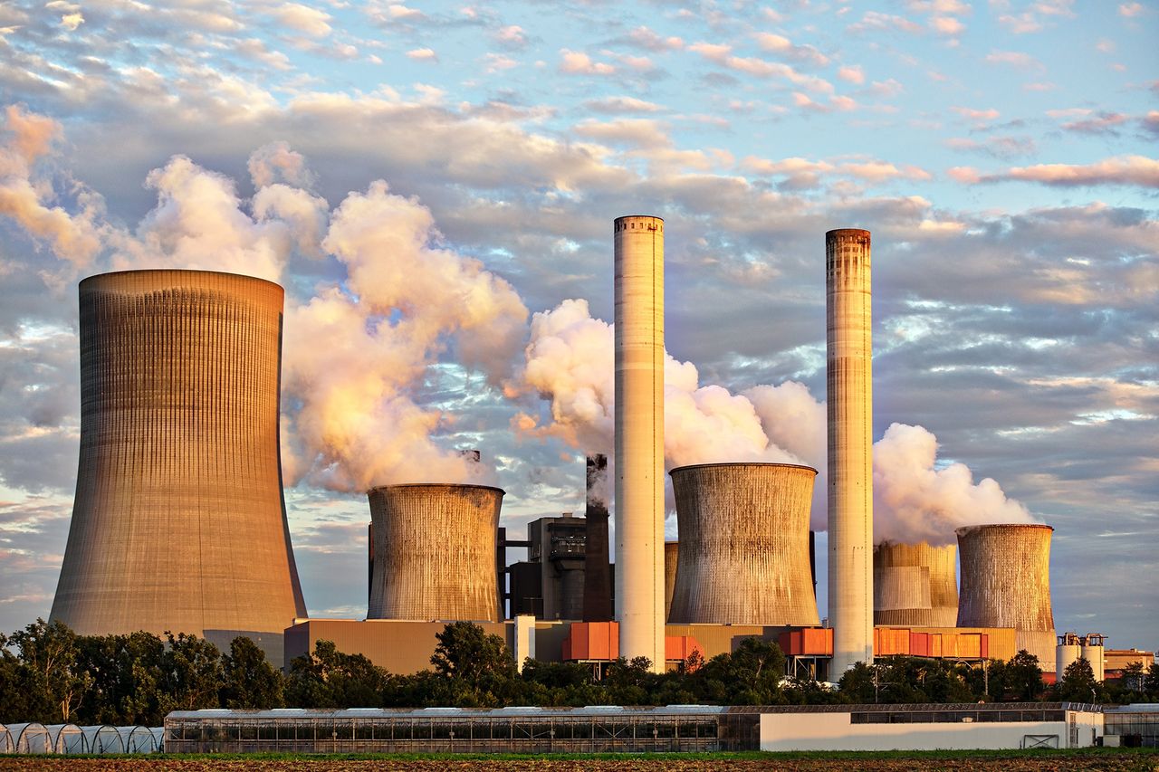 Oil storage tanks with a rising price chart, representing an oil price surge