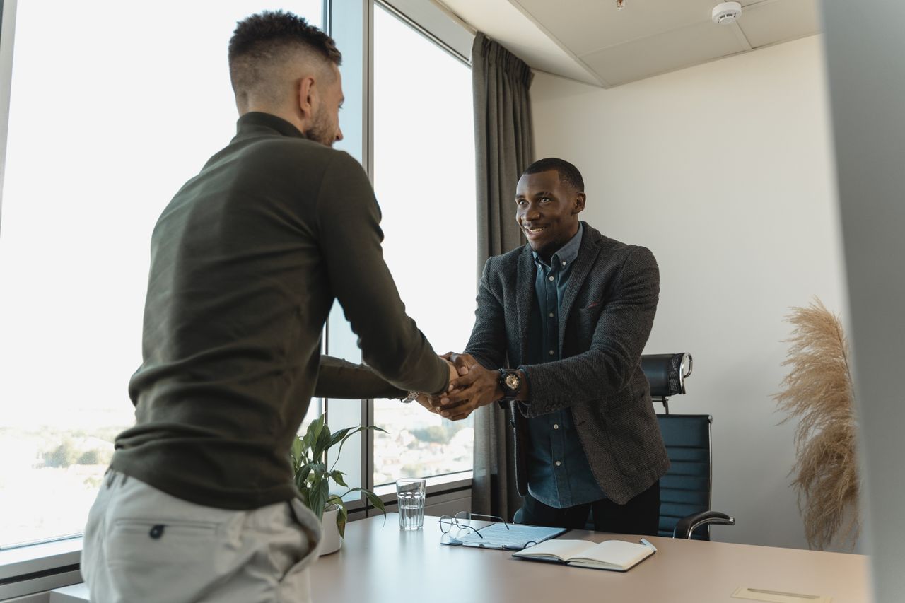 A job interview handshake, representing hiring and changing jobs for better pay