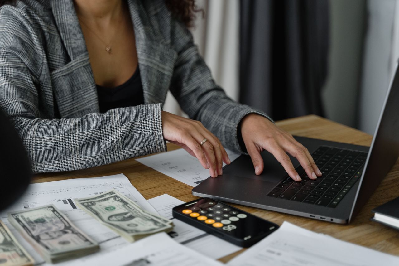 Person reviewing a loan amortization schedule with a calculator and documents