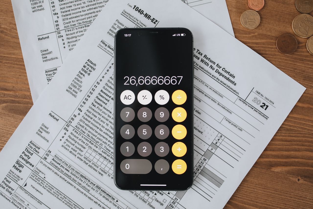 Tax forms with a calculator on a desk, the basics of understanding your taxes