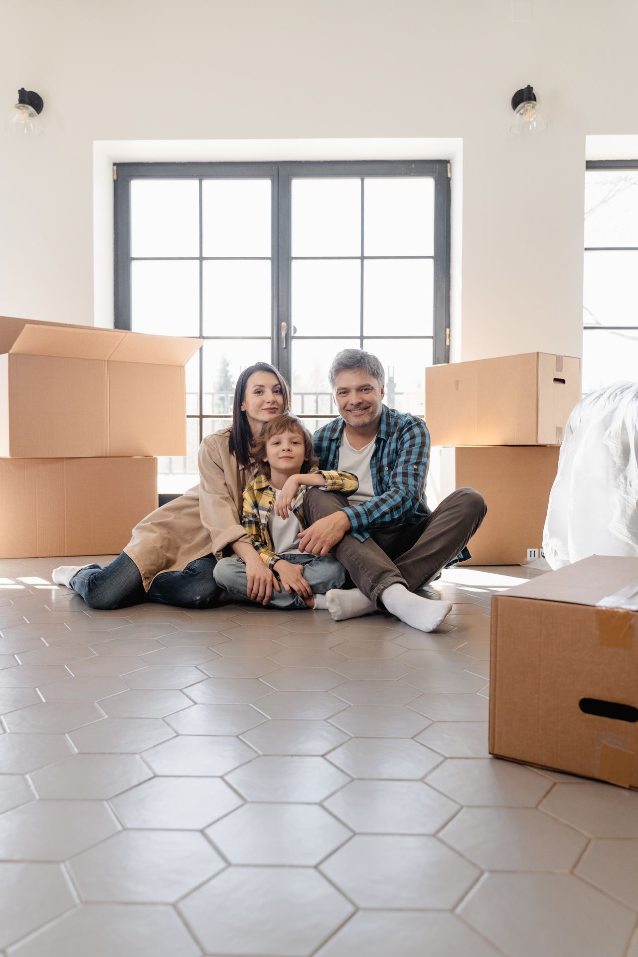 A house model beside a calculator and mortgage paperwork weighing rate options