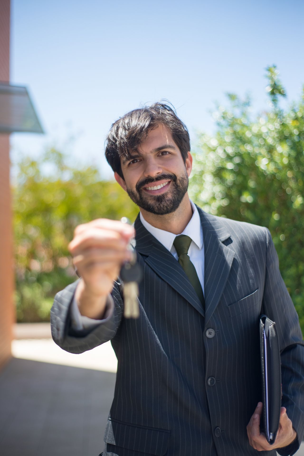 Homeowner receiving keys after closing on a refinanced mortgage