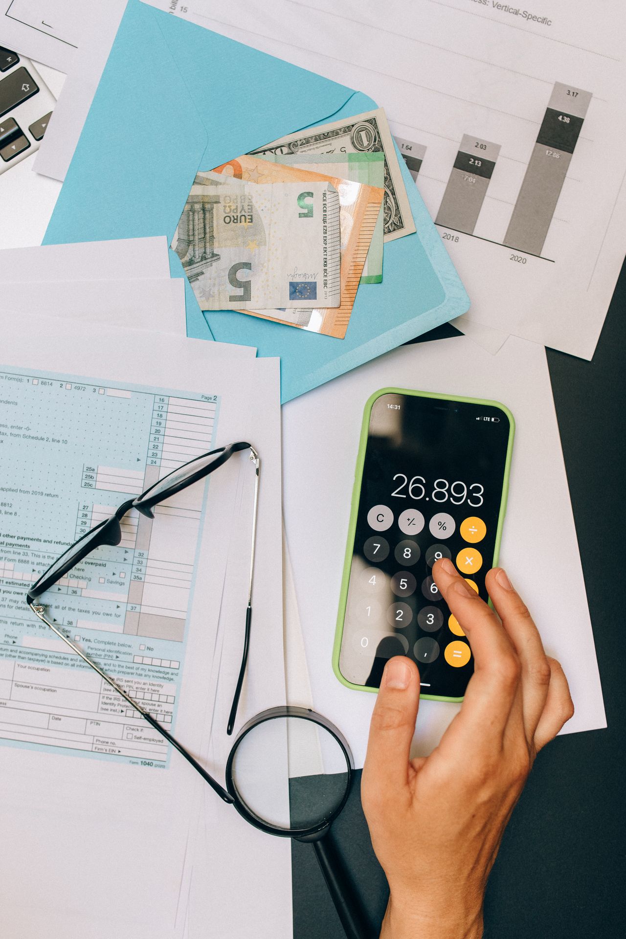 Tax forms with a calculator and pen, representing tax credits and deductions