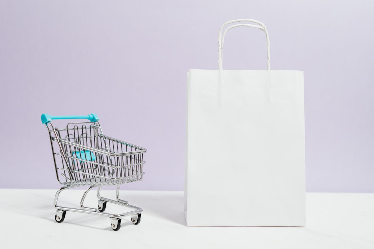 Shopper with a cart in a store aisle as retail spending slows