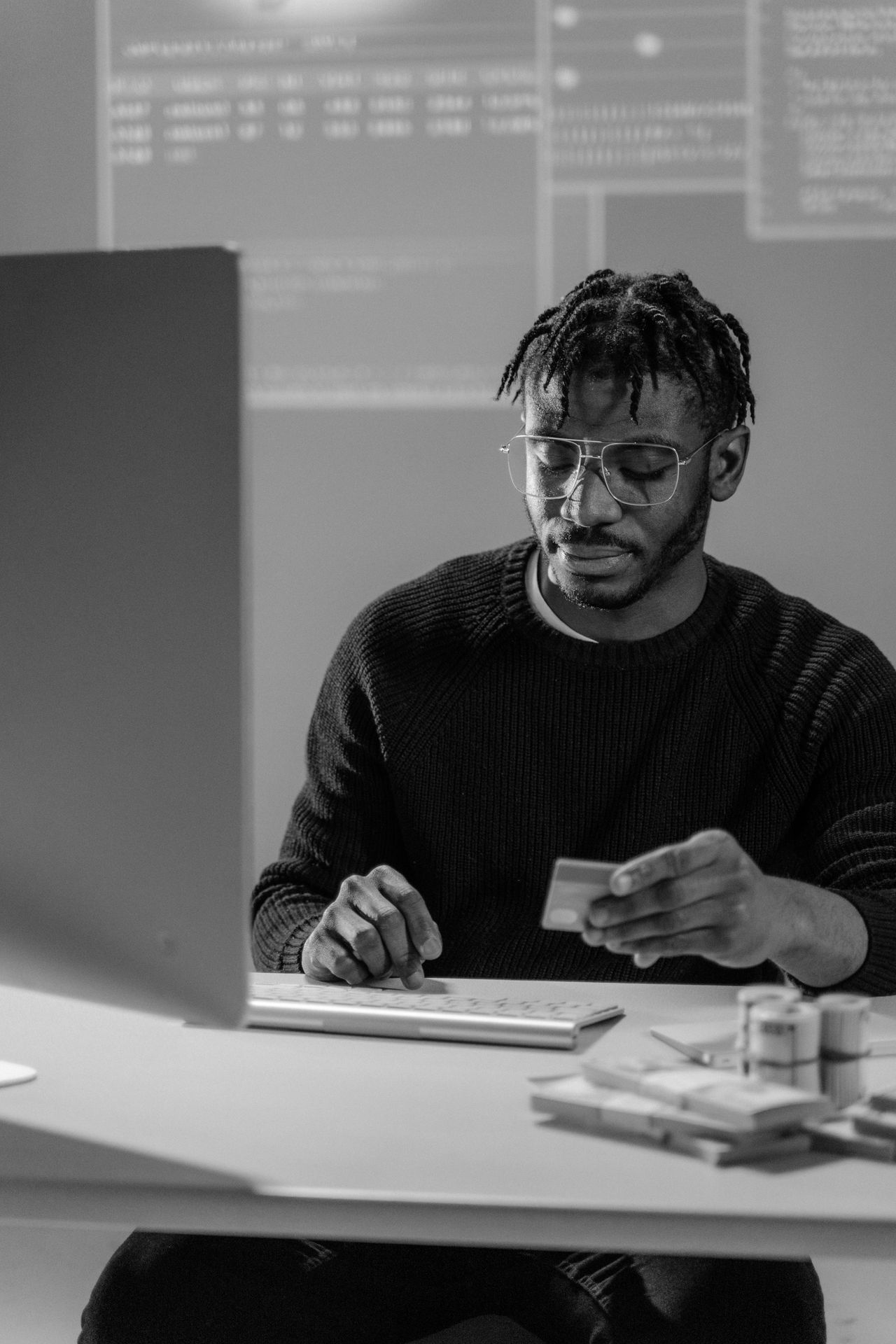 Person reviewing finances at a kitchen table, reflecting low consumer confidence